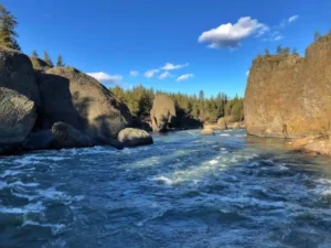 brown rock formation on body of water