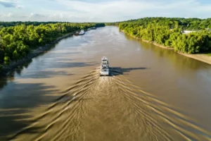 white and black boat on river during daytime