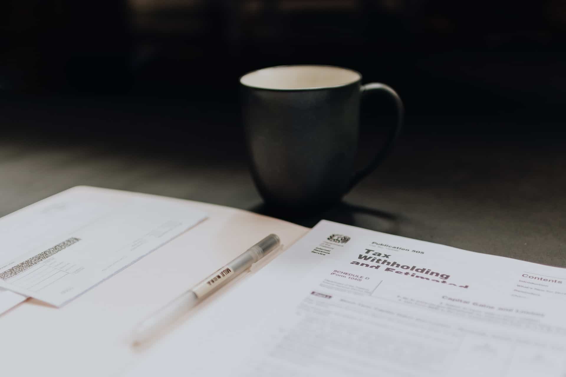 coffee mug near documents