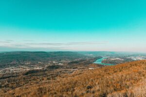 landscape with clear blue sky overlooking a river in distance