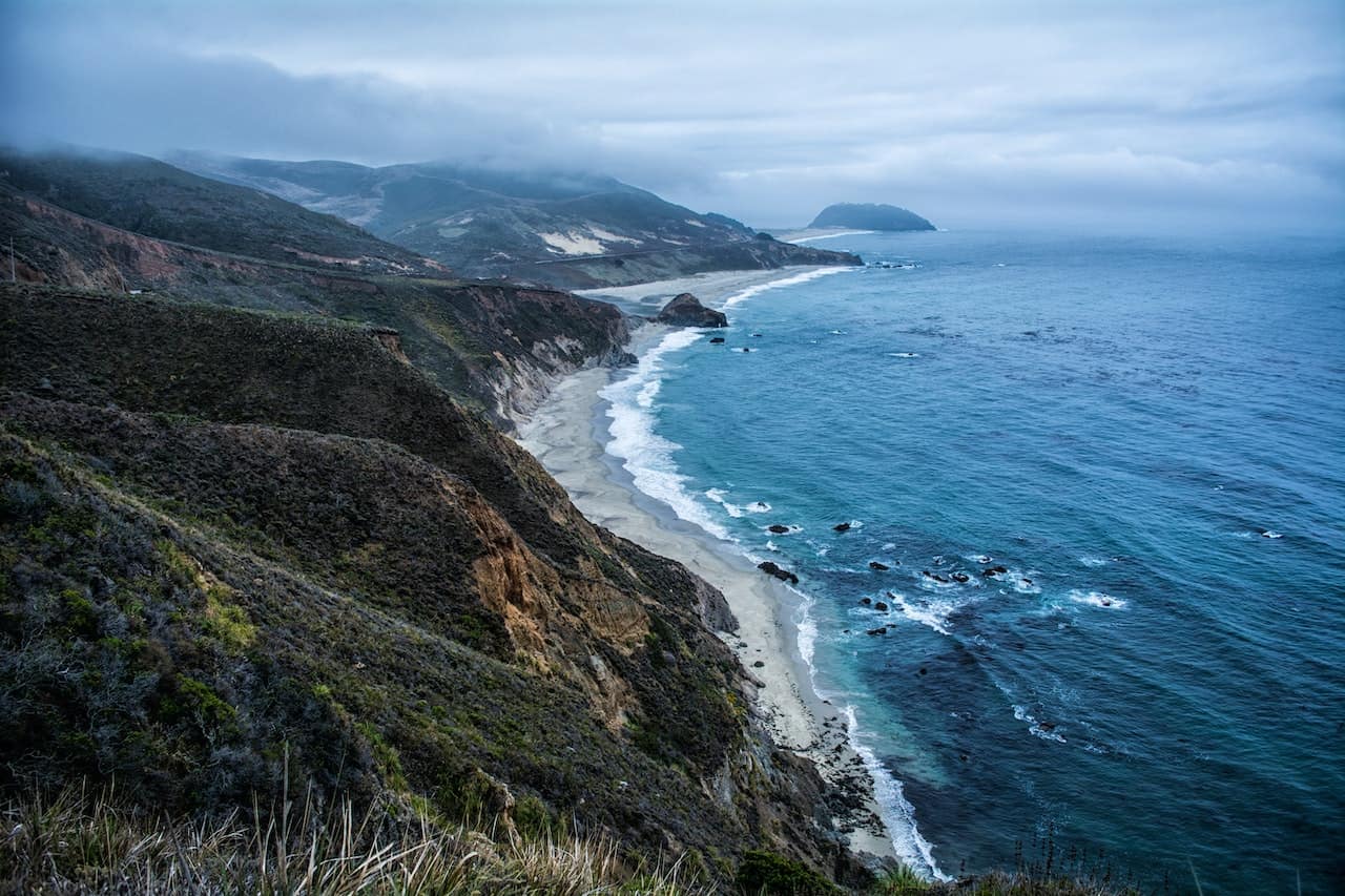 bay of water along green mountains