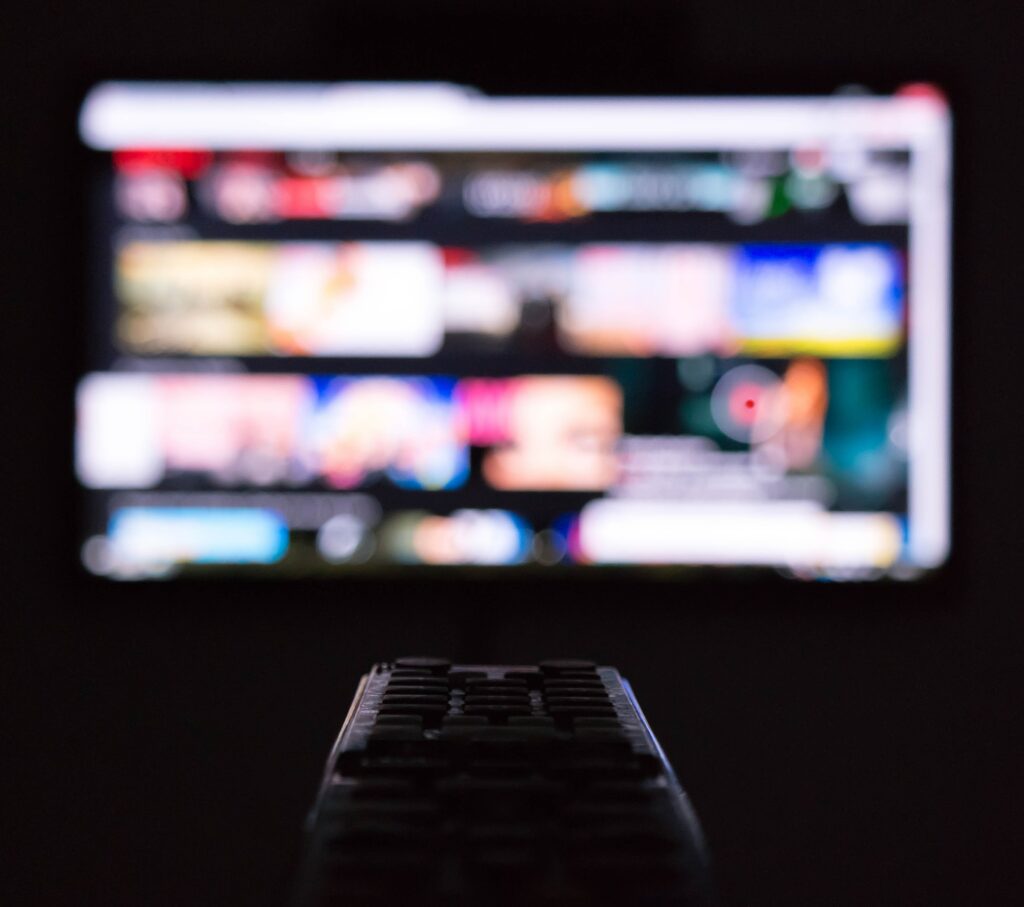 Media on a screen with a remote control in the center 