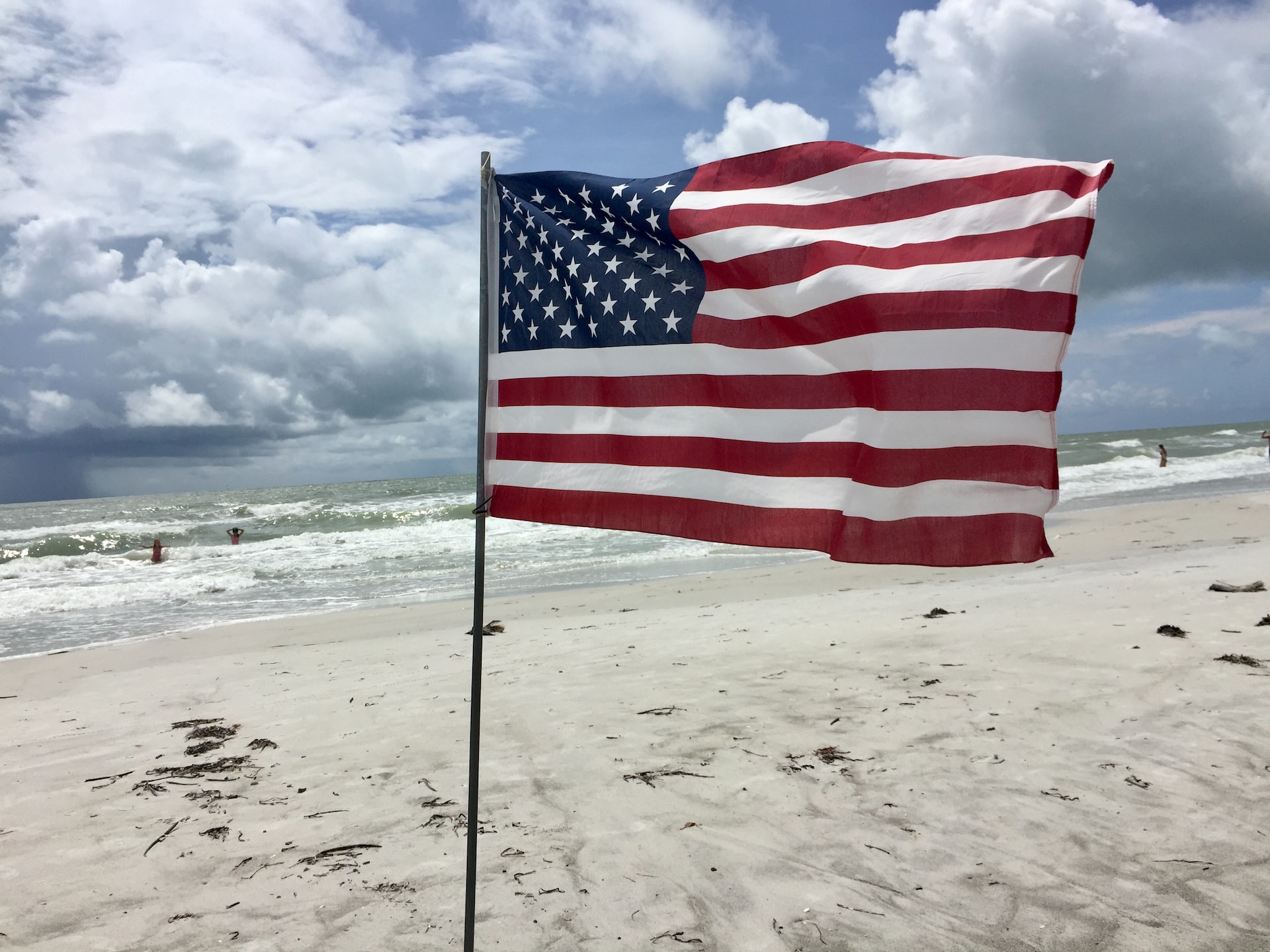 us a flag on beach during daytime for Labor Day